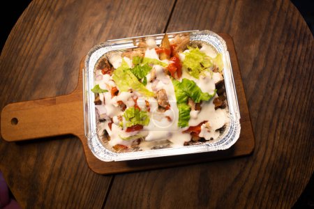 Pizza Loaded Fries topping with mayo and chilli sauce served in dish isolated on wooden board top view of italian fastfood spices