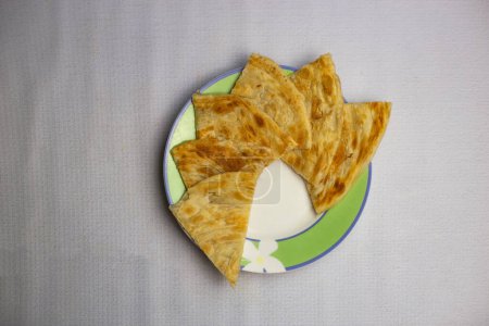 Photo for Shahi Paratha or porota slice served in plate isolated on background top view of bangladeshi, indian and pakistani traditional spicy food - Royalty Free Image