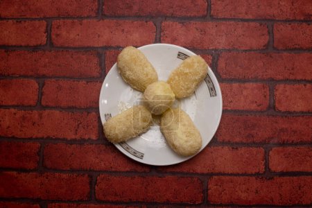 Shor roll Bhog sweet served in plate isolated on background top view of bangladeshi dessert food