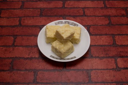 Kacha Chana barfi dal sweet served in plate isolated on background top view of bangladeshi dessert food