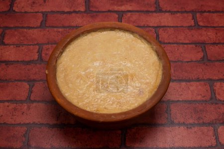 Mishti Doi or sweet yogurt served in plate isolated on background top view of bangladeshi dessert food
