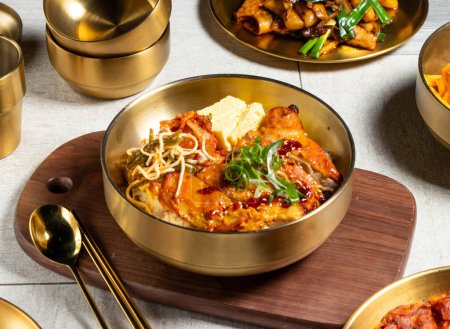 Téléchargez les photos : Andong Grilled Chicken Leg Bento avec cuillère et baguettes servi dans un plat doré isolé sur une planche de bois vue de côté de la nourriture kong kong - en image libre de droit