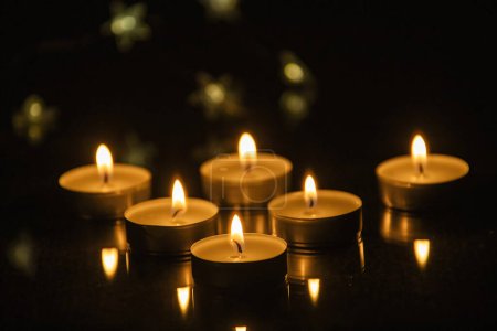 Photo for Candles shining in the darkness - Royalty Free Image