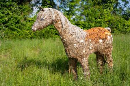 Handcrafted Straw Horse Sculpture in Natural Setting