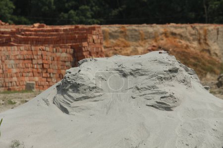 Photo for Piles of sand in the brick background - Royalty Free Image
