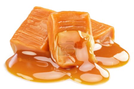 Milk caramel candies covered with melt caramel isolated on white background.