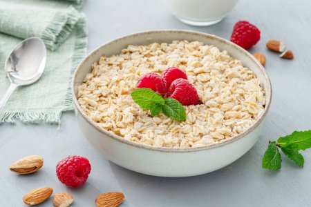 Photo for Bowl of porridge or oatmeal with fruits close up. Breakfast concept. - Royalty Free Image