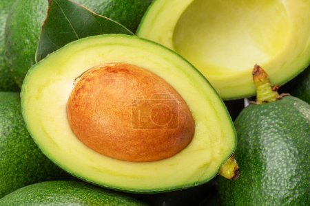 Photo for Lot of avocado fruits with leaves close up. Food background. - Royalty Free Image