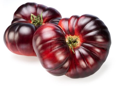 Ripe black or purple tomatoes isolated on white background. 