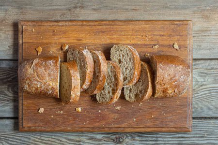 Fresh baked buckwheat (whole grain) bread, on a wooden background. Crispy baguette with a delicate crumb, craft bread. Sourdough ciabatta. Yeast-free baked goods.