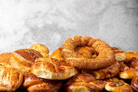 Bagel and pogaca varieties. They eat pastries in piles. Bakery products. Traditional turkish cuisine breakfast culture. Local name simit, pogaca, borek, acma. close up
