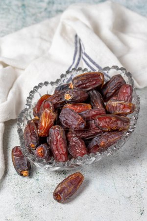 Photo for Date fruit on stone background. Organic Medjoul dates in a glass bowl. Ramadan food. close up - Royalty Free Image
