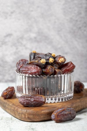 Photo for Date fruit on stone background. Organic Medjoul dates in a glass bowl. Ramadan food. close up - Royalty Free Image