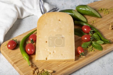 Gouda cheese. Piece of gouda cheese on wooden cutting board. Cheese collection. Ripe hard cheese made from cow's milk in the Netherlands