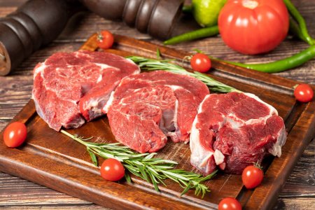 Photo for Raw boneless beef shank. Uncooked beef shank meat on a wood serving board - Royalty Free Image
