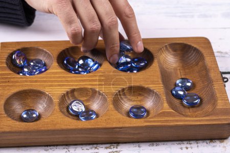 Mangala game board and glass marbles. Historical Turkish game mangala