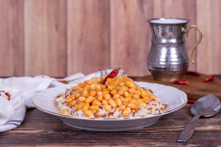 Photo for Dry bean pilaf. Traditional Turkish cuisine. Turkish dry beans and rice with ayran and hot pepper. local name kuru fasulye pilav - Royalty Free Image