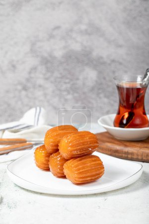 Photo for Tulumba dessert. Ramadan sweets. Traditional Turkish cuisine delicacies. Tulumba dessert with syrup on a gray background. - Royalty Free Image