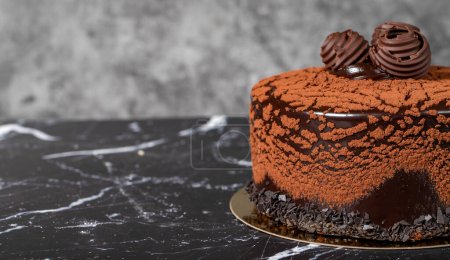 Photo for Chocolate cream cake. Birthday or celebration cake. Cake with cocoa and chocolate cream on a dark background. Copy space. Empty space for text - Royalty Free Image