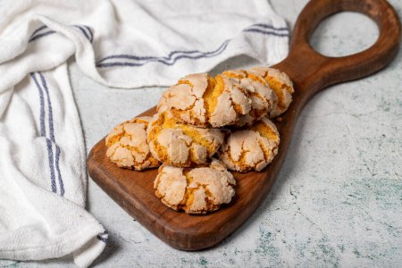 Photo for Orange cookies. Cracked delicious cookies on wood serving board - Royalty Free Image
