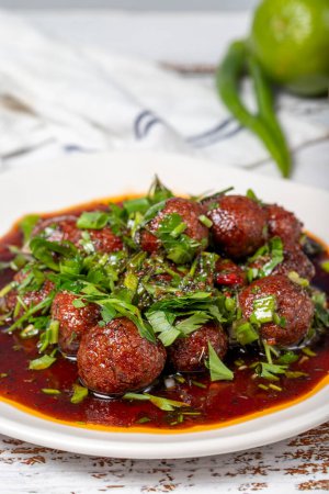 Aleppo meatballs. Traditional Asian flavors. Meatballs with tomato paste. Aleppo meatballs on white wood background. Close up