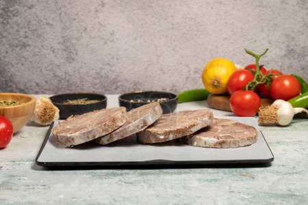Roast beef. Butcher products. Roasting sliced beef on stone background