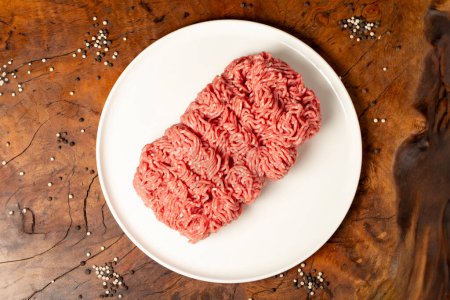 Ground beef. Butcher products. Fresh minced meat on dark background. Top view