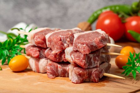 Lamb sirloin. Lamb sirloin meat skewered on a wooden serving board