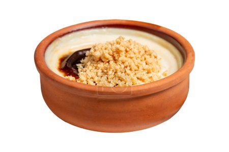 Rice pudding isolated on white background. Milky dessert. Oven-baked rice pudding dessert in a clay bowl. Close up