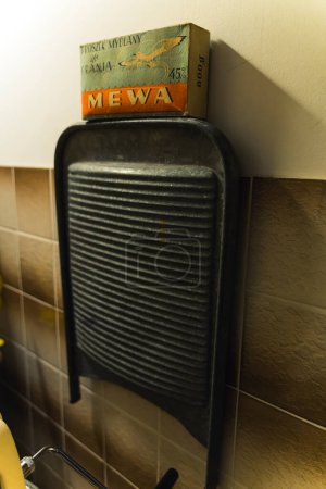 Photo for 10.20.2022 Warsaw, Poland. Museum of Life under Communism. Old bathroom heater along with authentic vintage washing powder packaging - Mewa. Vertical shot. High quality photo - Royalty Free Image