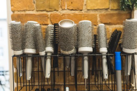 Photo for Set of different hair brushes and combs on the wall at the barbershop. High quality photo - Royalty Free Image