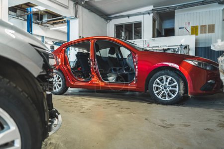 Foto de Red car body at automobile repair service center. indoor shot. High quality photo - Imagen libre de derechos