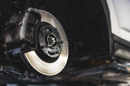 Téléchargez les photos : Closeup disc brake of vehicle for repair - Tire replacement car brake repairing. High quality photo - en image libre de droit