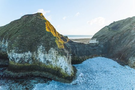Photo for A view of the beach and surrounding rock formation at the North Landing at Flamborough Head on the north Yorkshire coast. High quality photo - Royalty Free Image