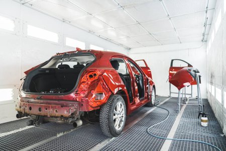 un coche y sus partes después de pintar en el taller de pintura, tiro completo, reparación después de un accidente. Foto de alta calidad