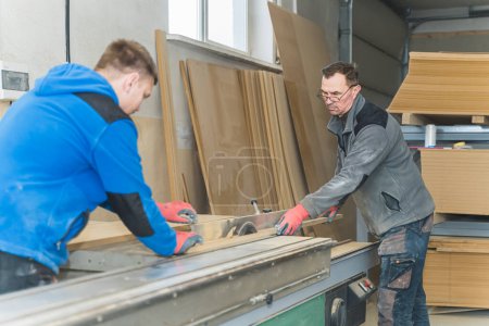 Foto de Dos carpinteros trabajando juntos en un taller de carpintería, artesanos. Foto de alta calidad - Imagen libre de derechos