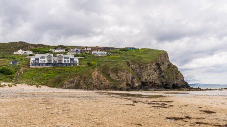 Photo for Porthtowan, Cornwall, England, UK - June 06, 2022: Houses on the cliffs of Porthtowan Beach - Royalty Free Image