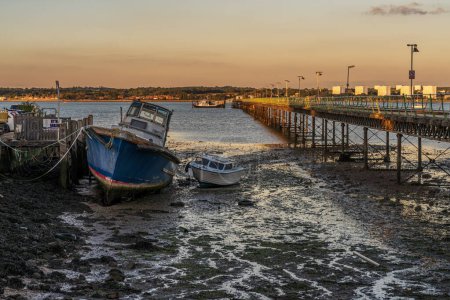 Photo for Hythe, Hampshire, England, UK - September 29, 2022: Evening light at Hythe Pier and a ferry departing - Royalty Free Image