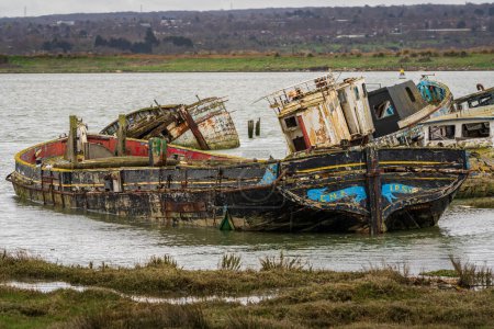 Photo for Hoo Marina Park, Kent, England, UK - March 21, 2023: Shipwrecks on the banks of the River Medway - Royalty Free Image