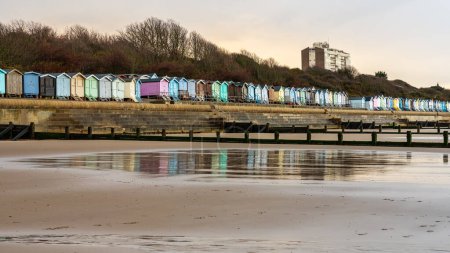 Beach huts on the North Sea coast at Frinton-on-Sea, Essex, England, UK