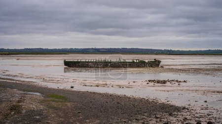 A shipwreck on the banks of The Swale near St Giles, Kent, England, UK