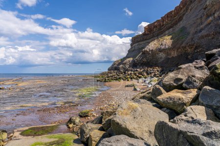 Low tide on the North Sea coast at the East Cliffs in Whitby, North Yorkshire, England, UK