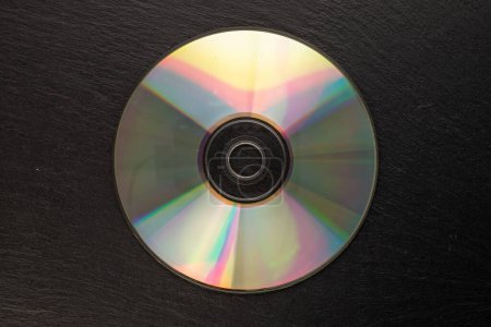 Photo for One CD-R disc on slate stone, macro, top view. - Royalty Free Image