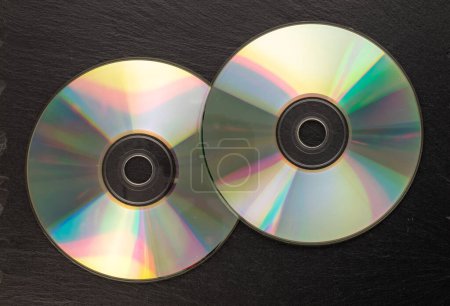 Photo for Two CD-R discs on slate stone, macro, top view. - Royalty Free Image