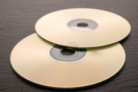 Photo for Two CD-R discs on slate stone, macro. - Royalty Free Image