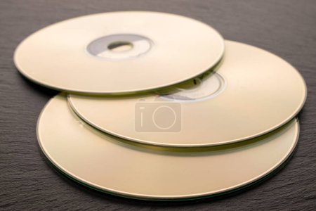 Photo for Three CD-R discs on slate stone, macro. - Royalty Free Image