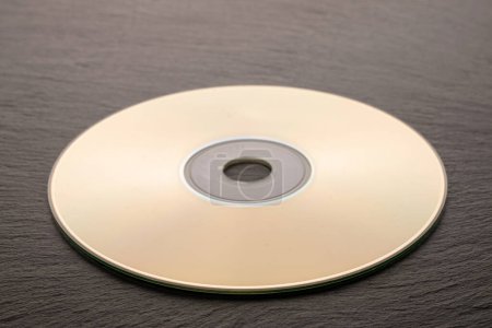 Photo for One CD-R disc on slate stone, macro. - Royalty Free Image