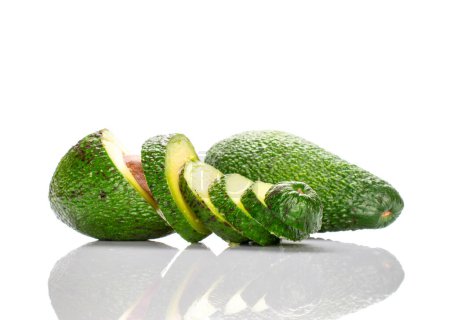 Photo for One whole green ripe avocado, the second avocado is cut into transverse braids and is nearby. The background is white. - Royalty Free Image
