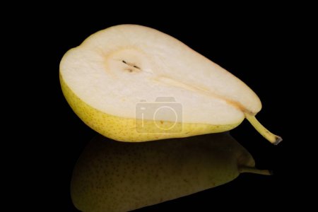 Photo for One half ripe pear, close-up, on a black background. - Royalty Free Image