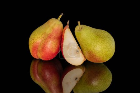 Photo for Two pears and one slice, close-up, on a black background. - Royalty Free Image